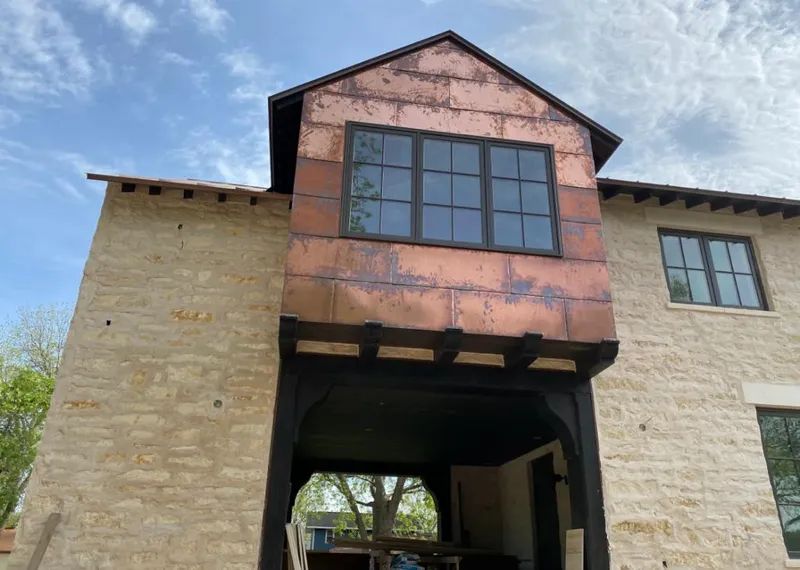 Copper metal panel facade on a stone building for Roof Repair in Pleasant Valley